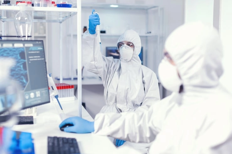 Scientists in full protective gear conducting experiments in a laboratory